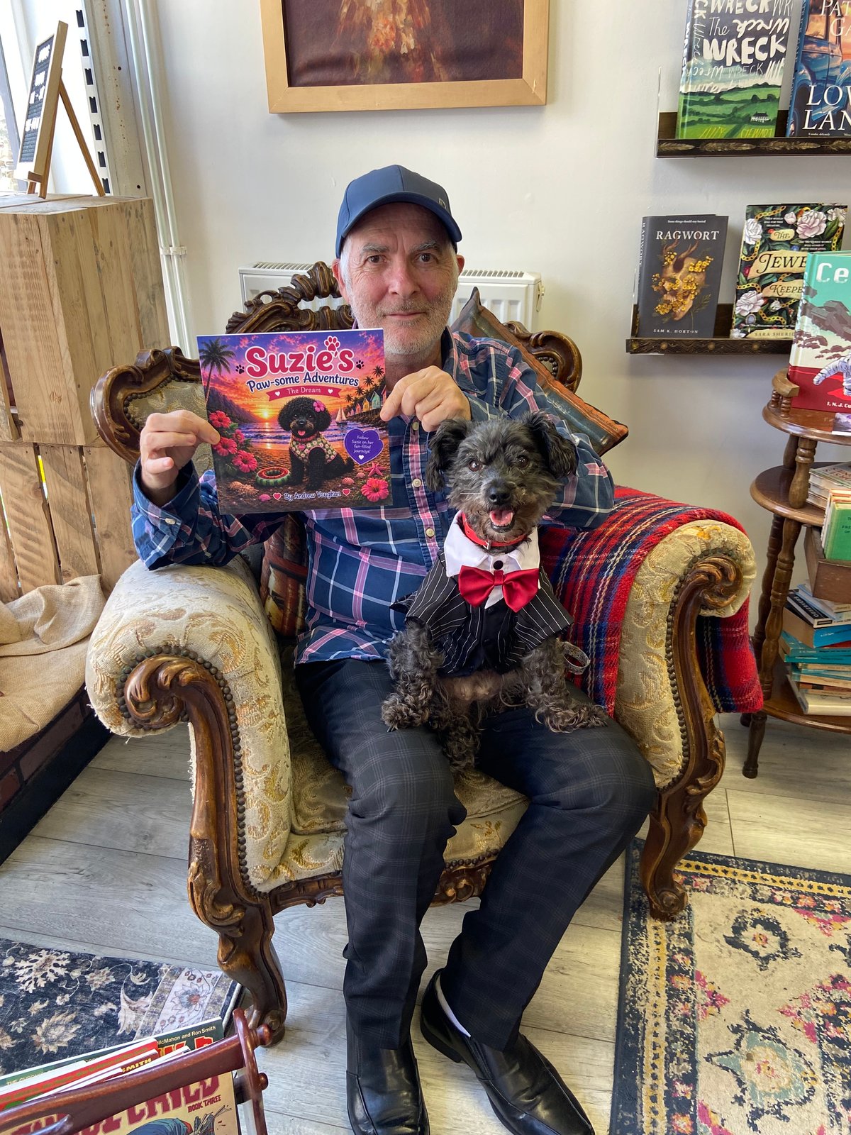 The real Suzie posing beside author Andrew Vaughan, who is holding the book